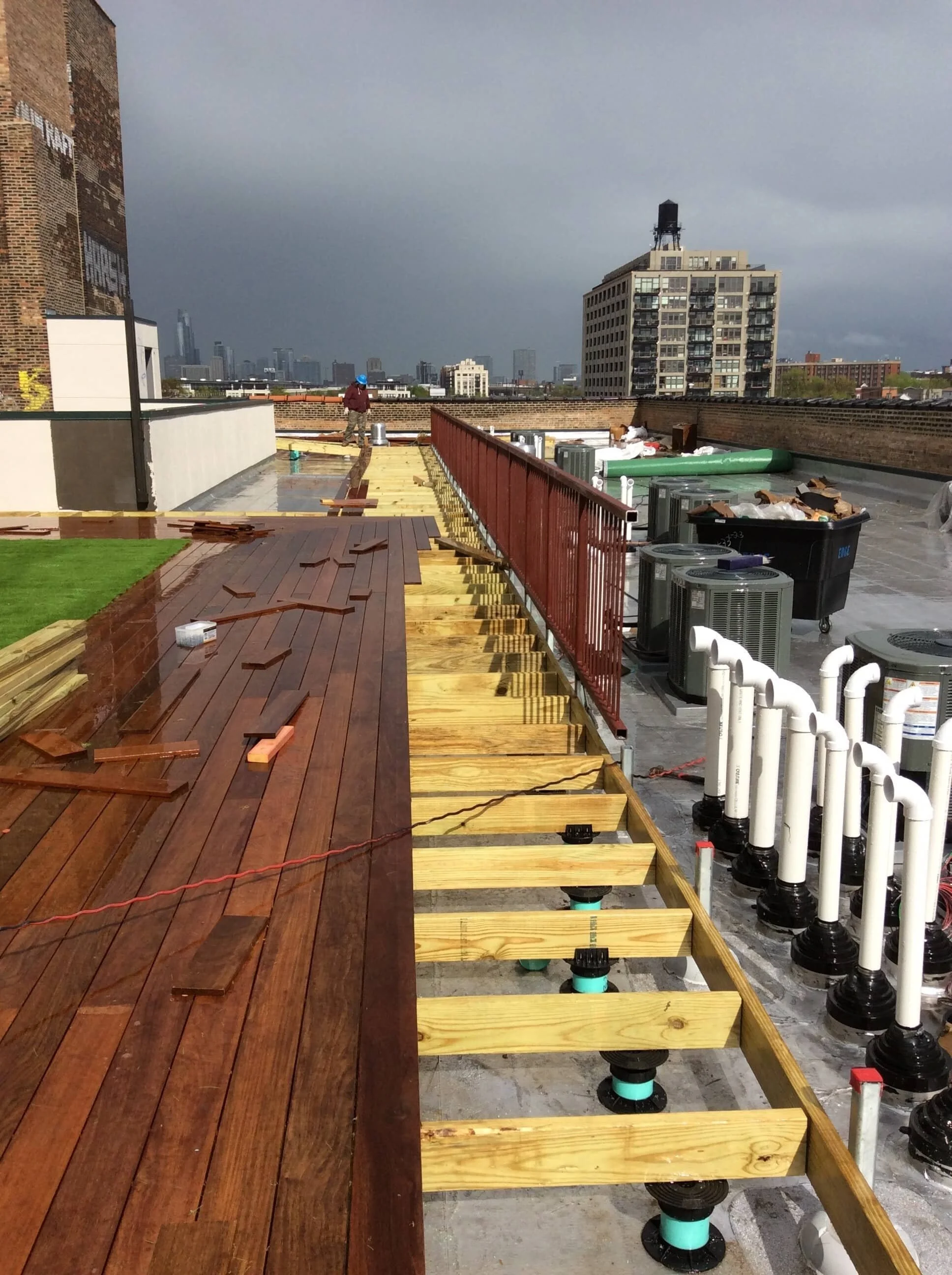 Rooftop deck framing with Chicago skyline — Otis deck project
